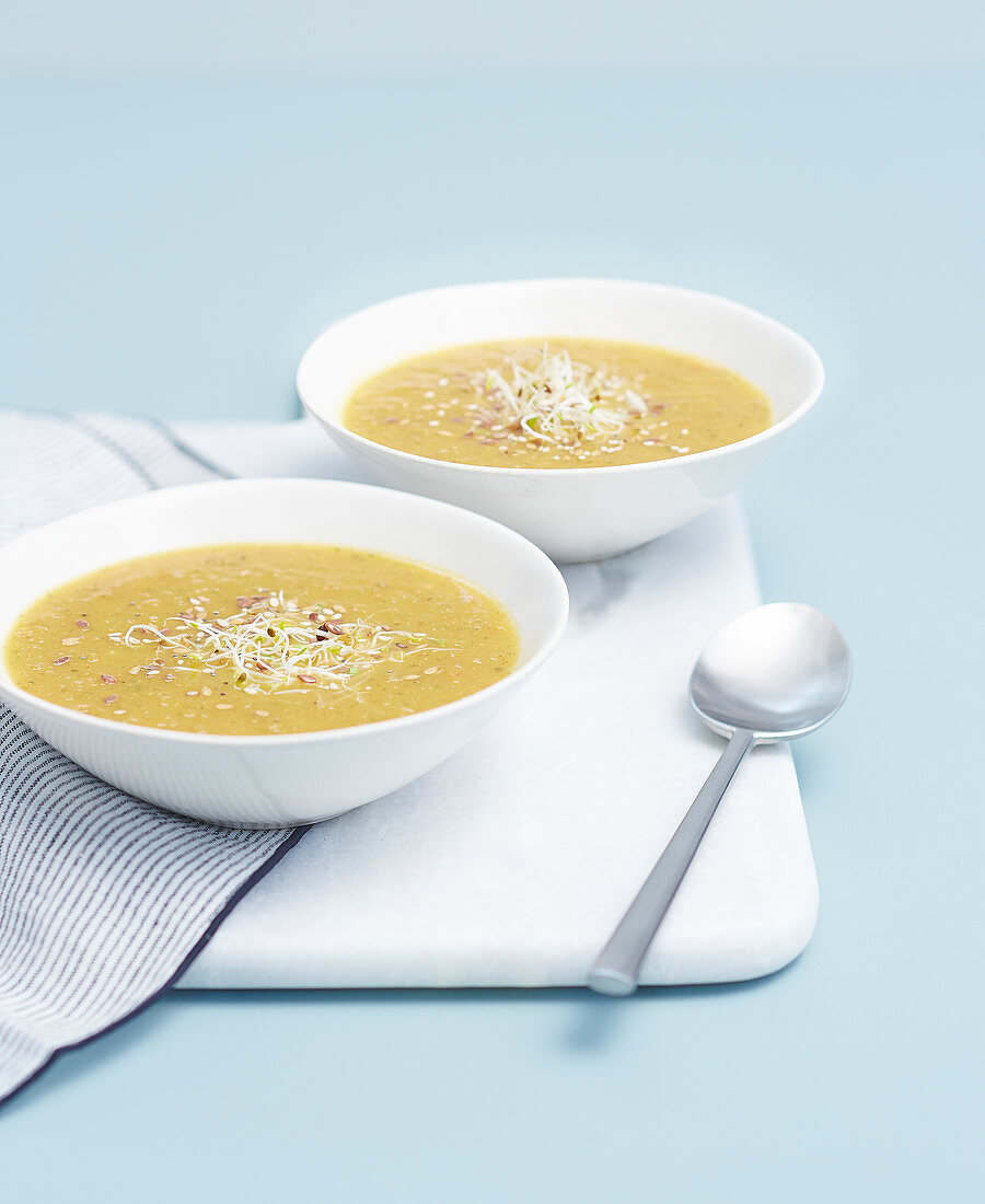 Cream of vegetable soup with sprouts and sesame seeds