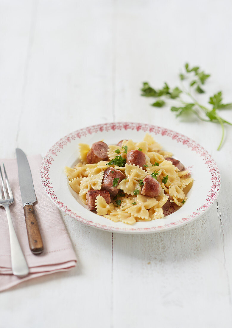 Farfalle with sliced sausage