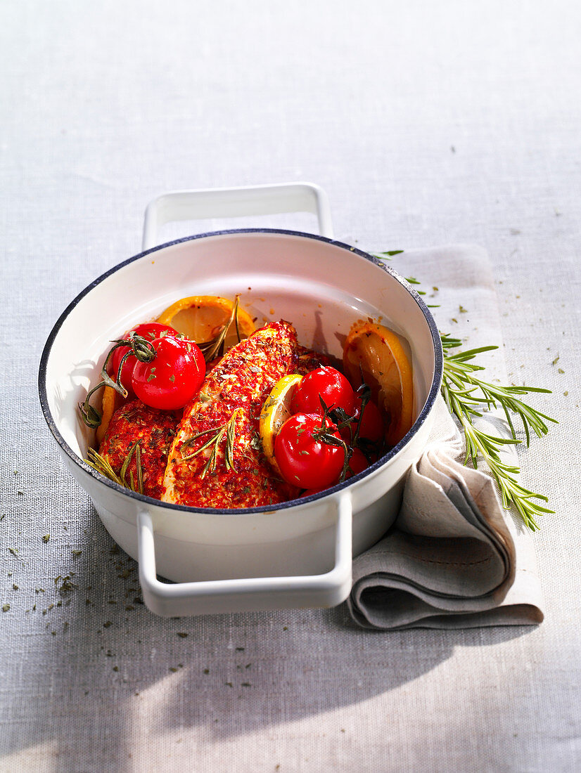Chicken breast with espelette pepper, tomatoes, lemons and rosemary
