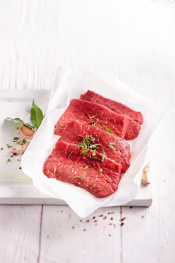 Raw beef fillets on paper