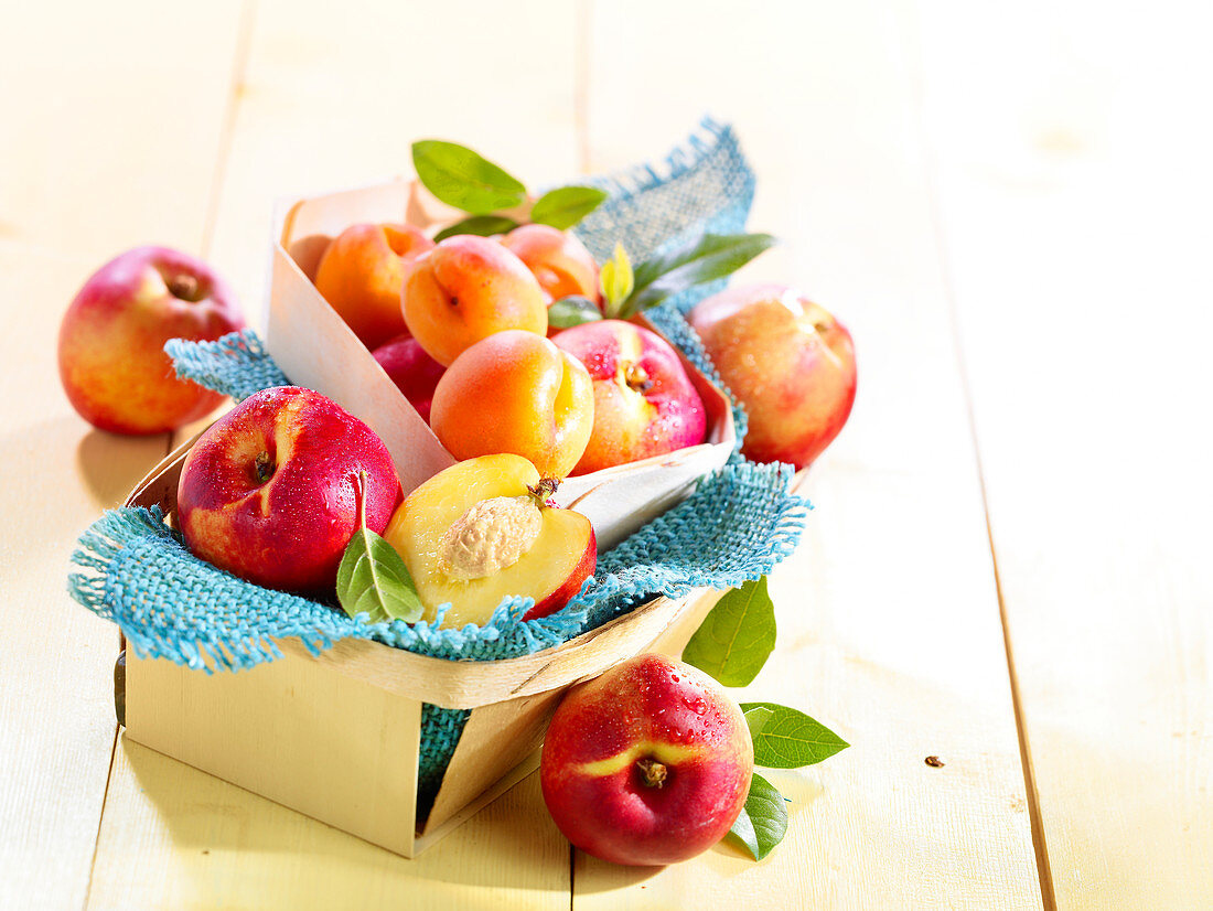 Nectarines and apricots in wooden baskets