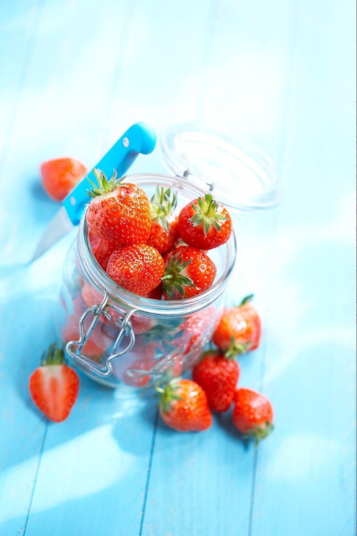 Fresh strawberries in a glass jar