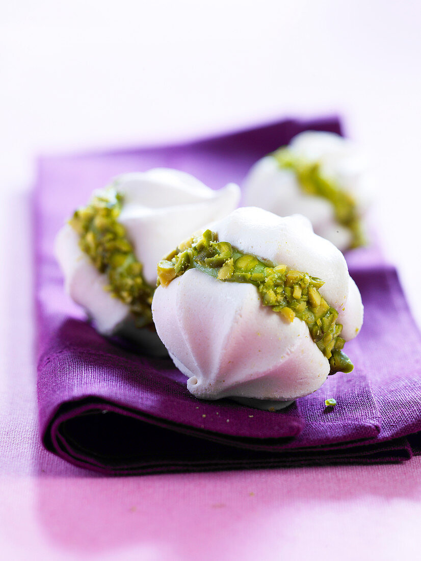 Meringue sandwich cookies with pistachio filling