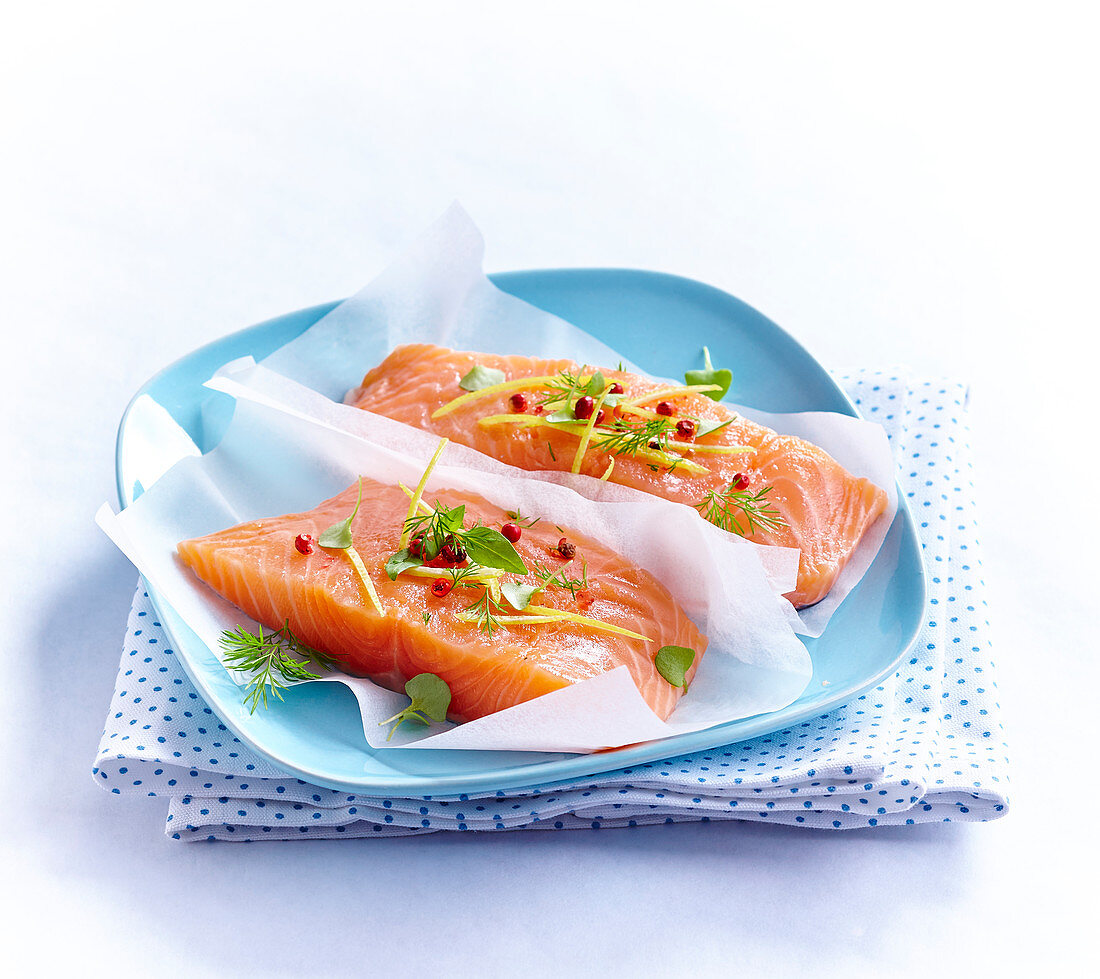 Two raw salmon steaks on paper