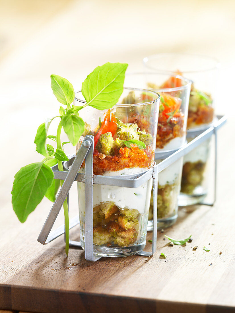 Savoury tiramisu with goat’s cheese and crushed tomatoes in glasses as a starter