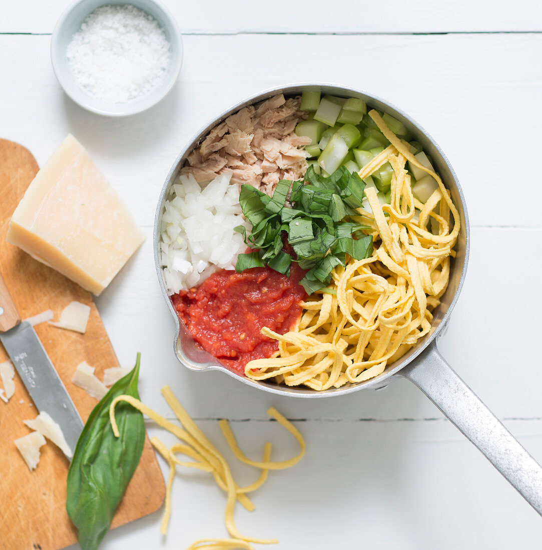 Ingredients for a pasta dish with tuna in a pot