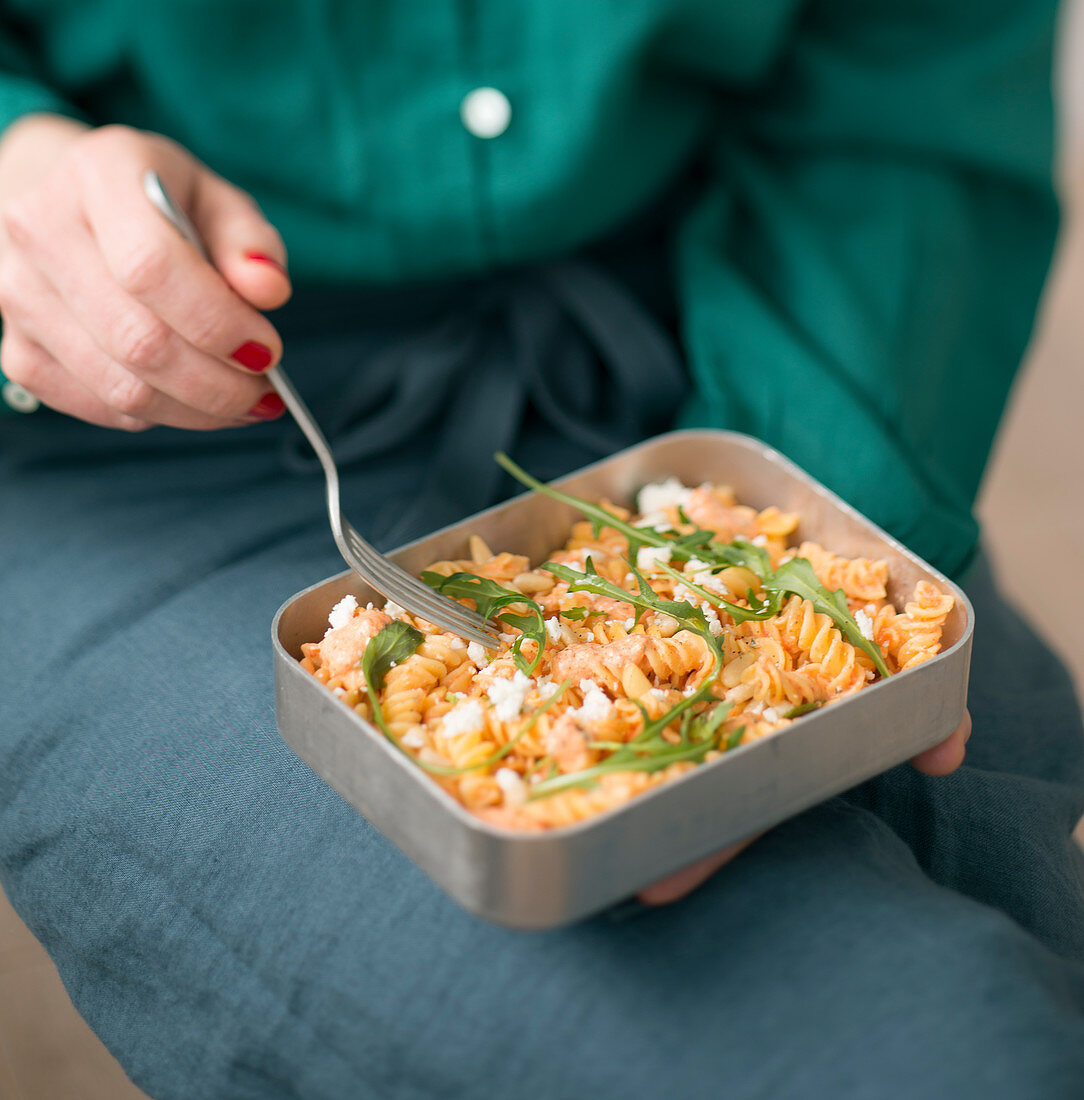 Fusilli with feta and rocket in a lunchbox for eating on the go