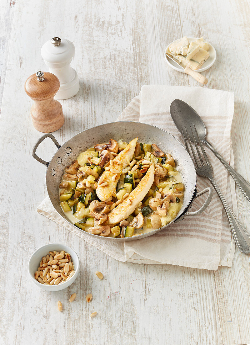 Chicken cassolette with mushrooms, courgettes, gorgonzola and pine nuts