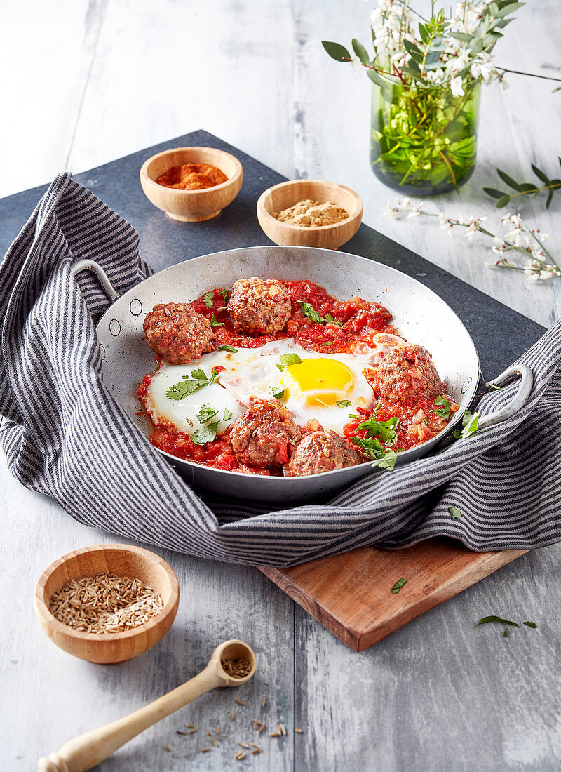 Meatballs with tomato sauce and a fried egg