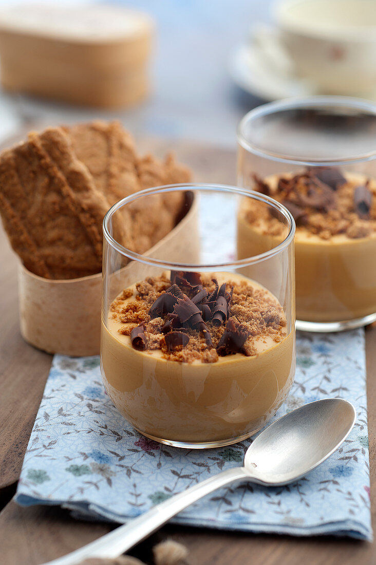 Dulce de Leche in dessert glasses with biscuit crumbs and chocolate
