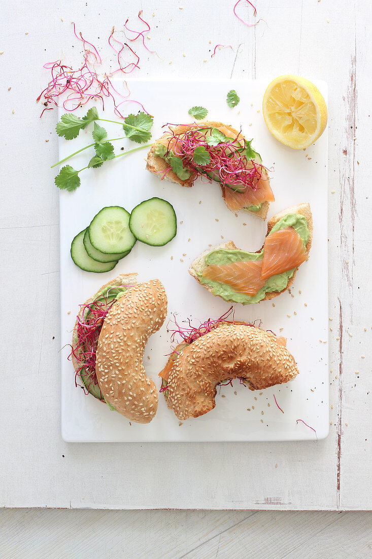 Bagel with avocado cream, smoked salmon, cucumber and sprouts