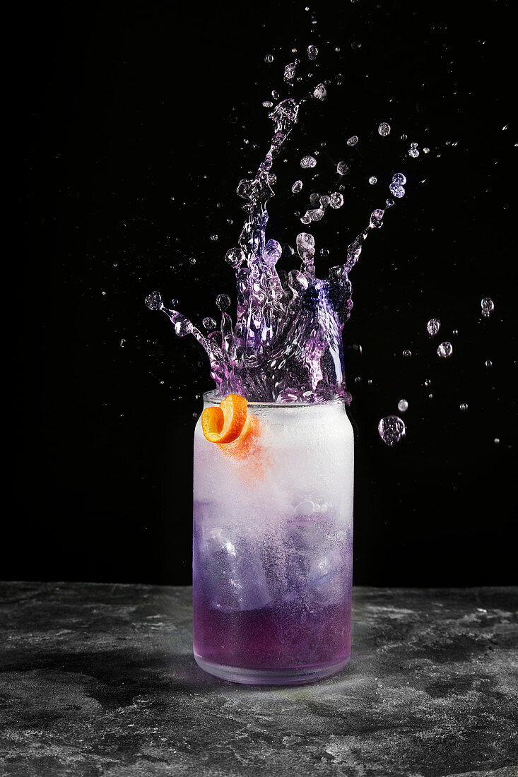 Purple soft drink with a splash
