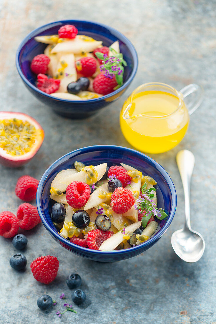 Fruit salad with summer fruits and passion fruit syrup