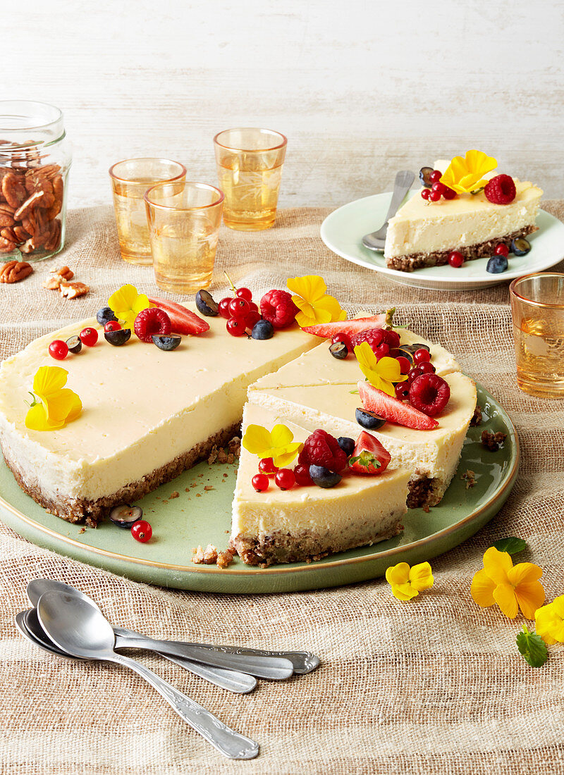Cheesecake garnished with berries and flowers