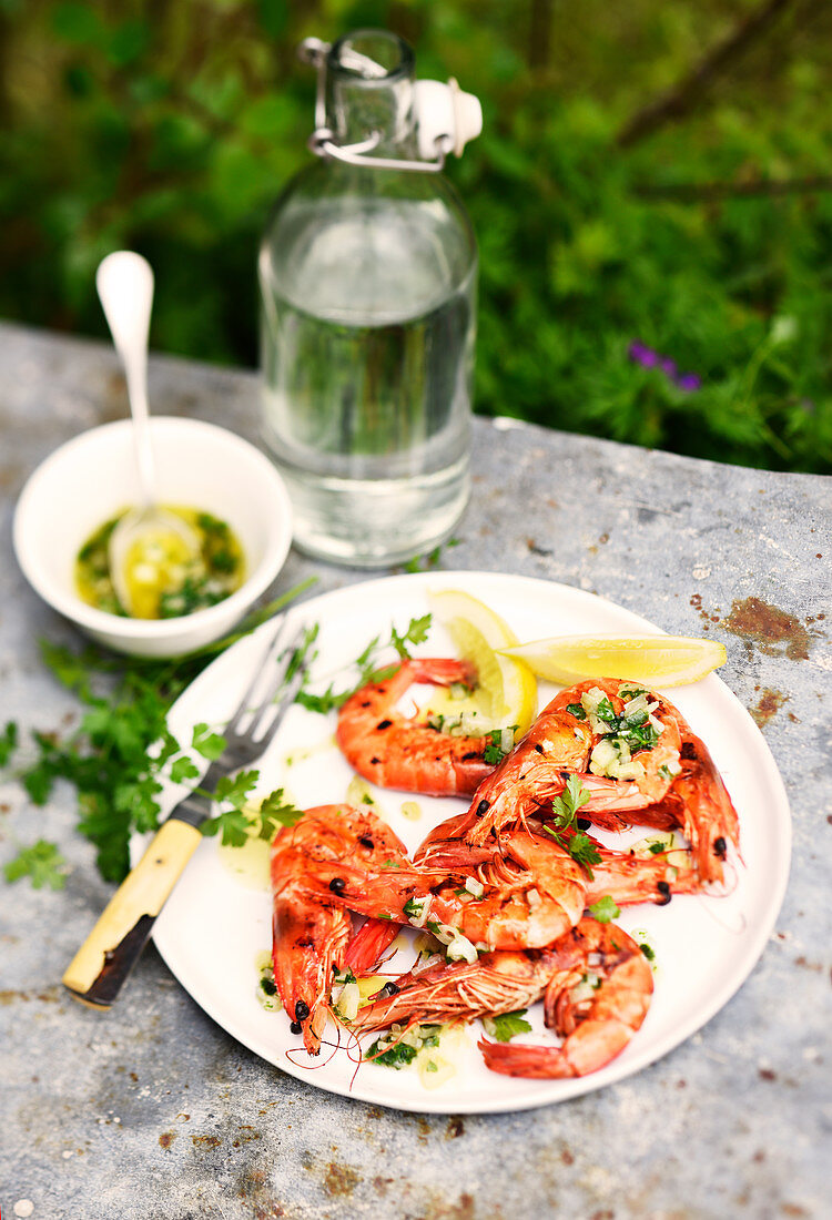 Flat iron grilled prawns with parsley butter and lemon wedges