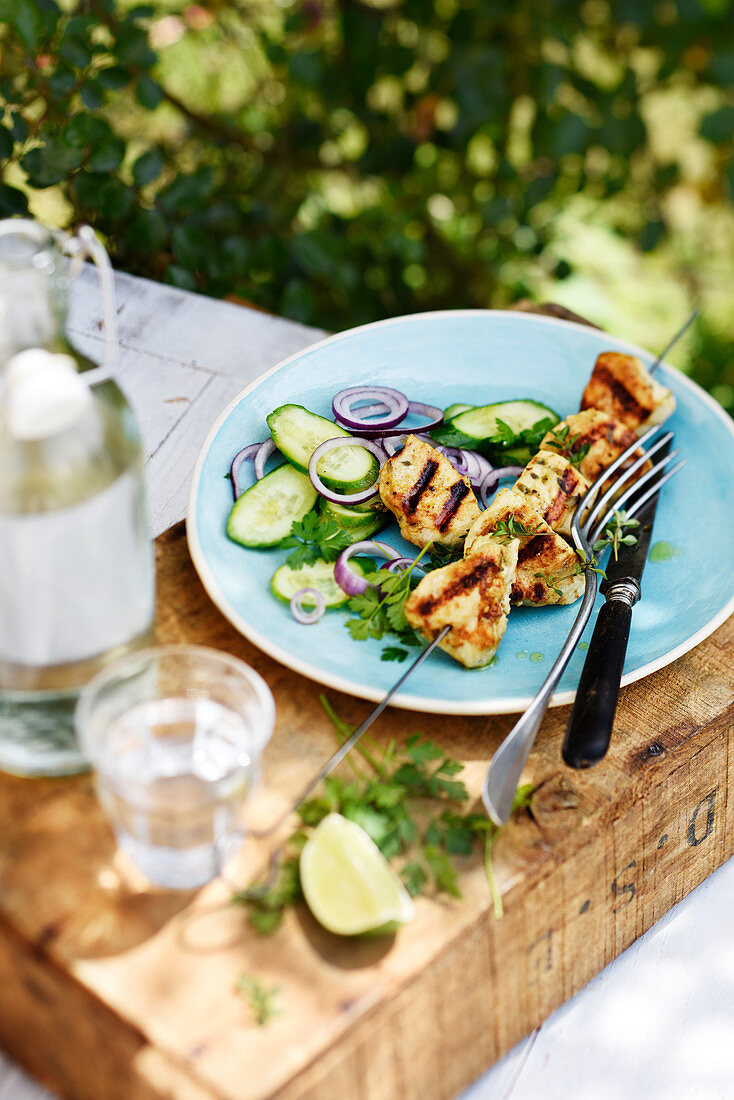 Marinated grilled chicken skewer on an outdoor table