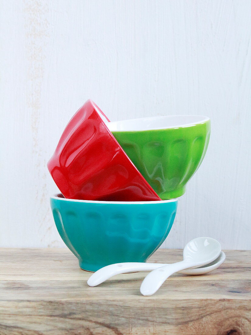 Three different coloured bowls stacked inside each other