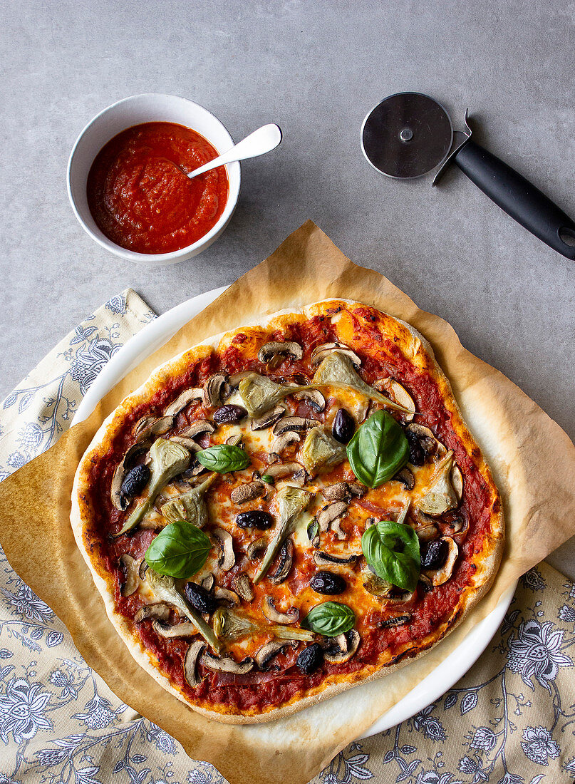 Four seasons pizza with ham, mushrooms, artichokes and olives