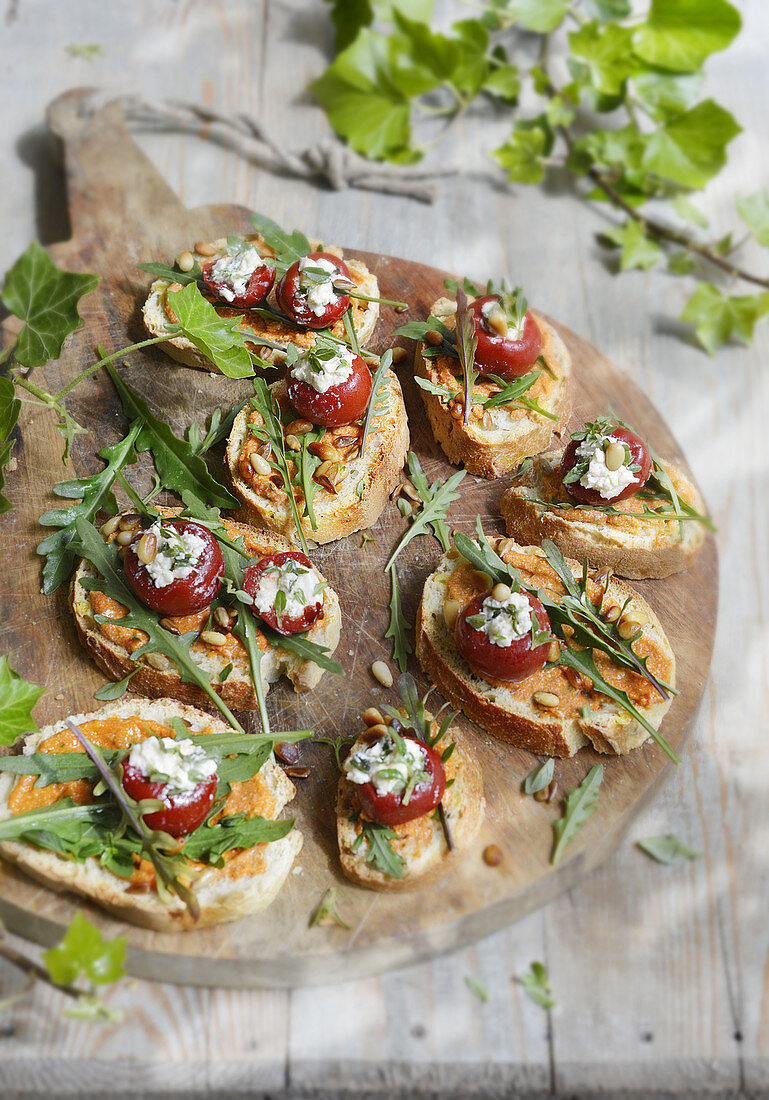 Bruschetta with hummus, rocket and stuffed piquillo peppers