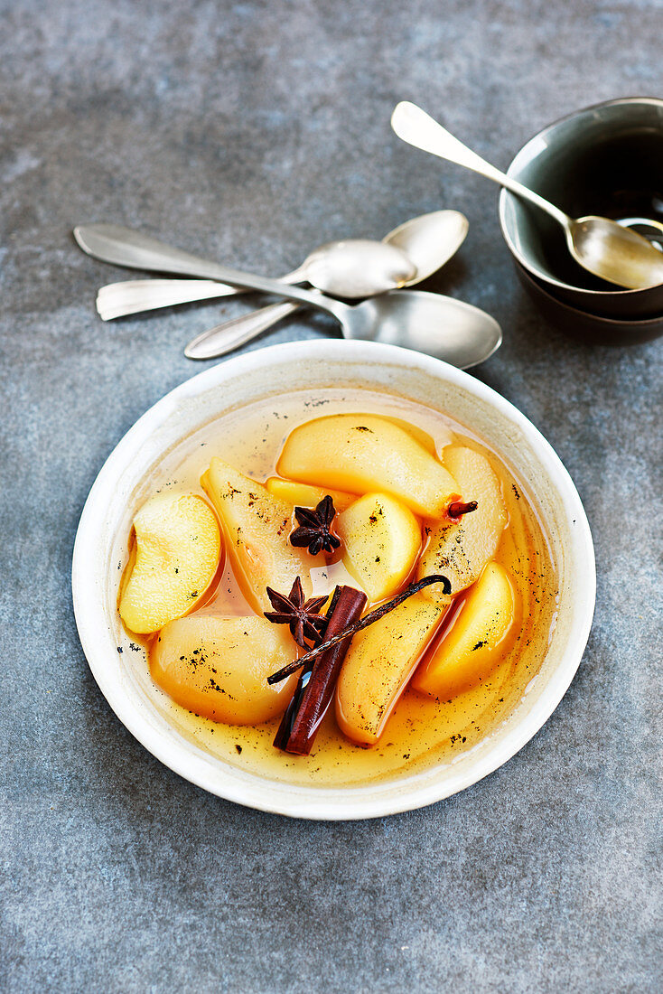 Poached apples and pears in syrup with spices