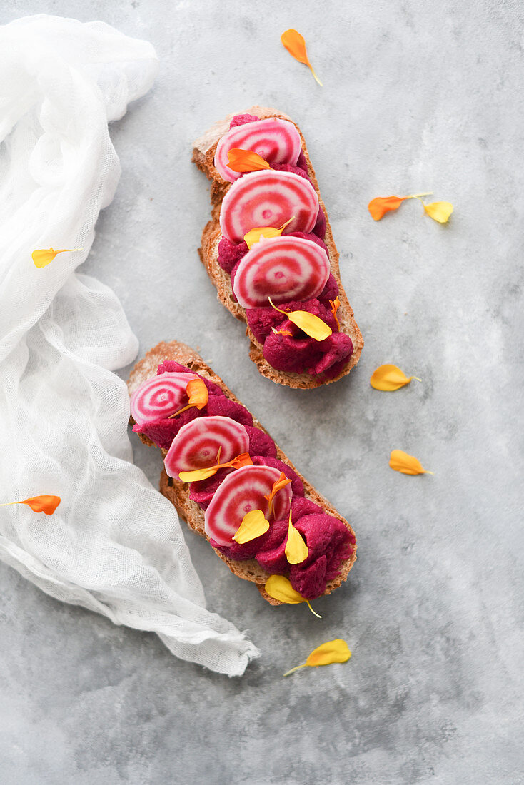 Bread with beetroot hummus decorated with slices of beetroot