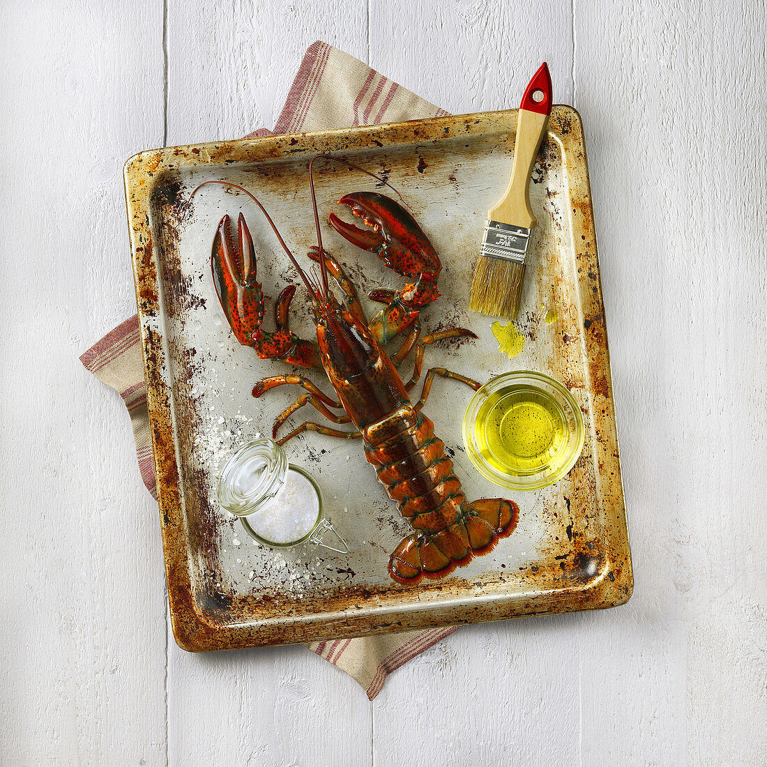 Lobster with salt and oil on an oven tray