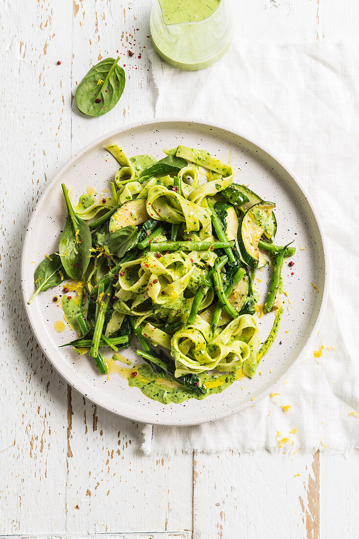Ribbon noodles with green summer vegetables and pesto