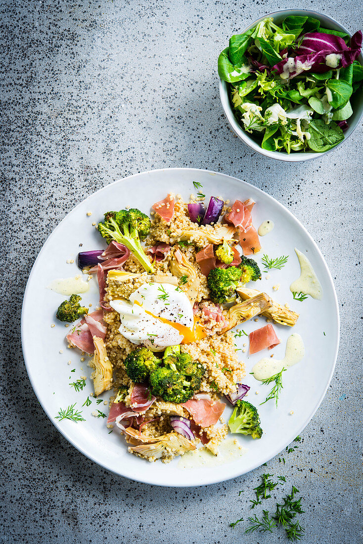 Quinoa salad with ham, artichokes, broccoli and poached eggs
