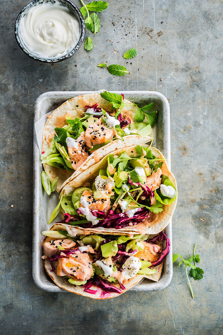 Tacos with salmon, avocado and red cabbage