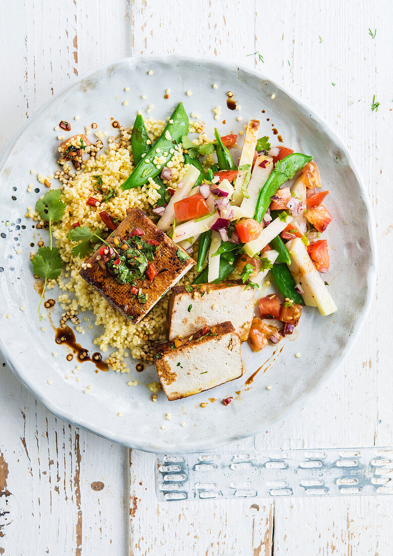 Grilled tofu with vegetable salad on couscous
