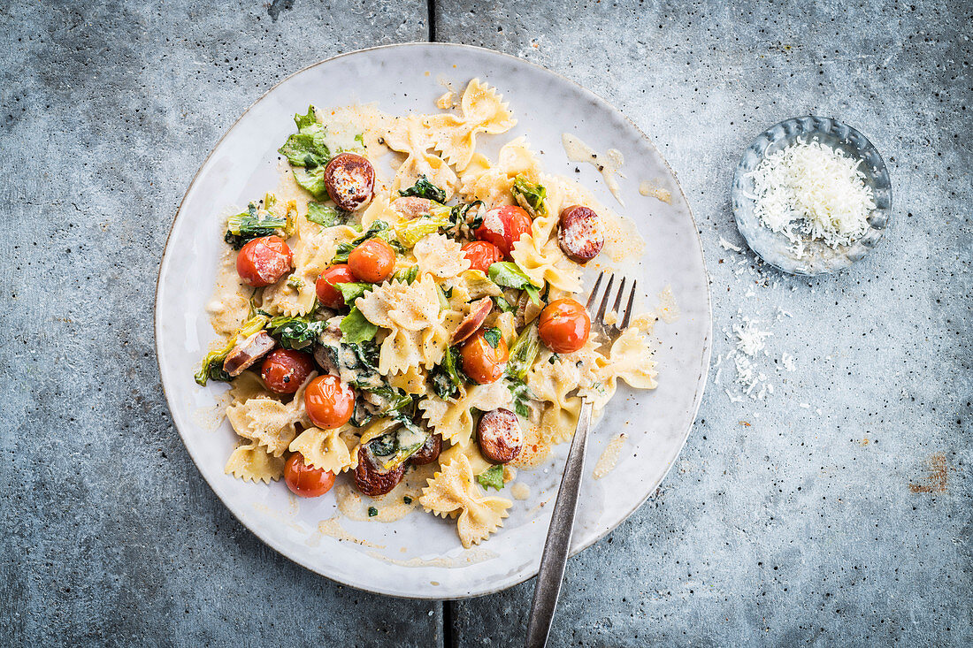 Farfalle with sausage, cherry tomatoes and parmesan sauce