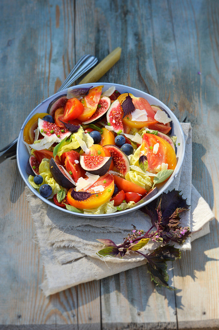 Summer salad with tomatoes, figs, peaches and shiso cress