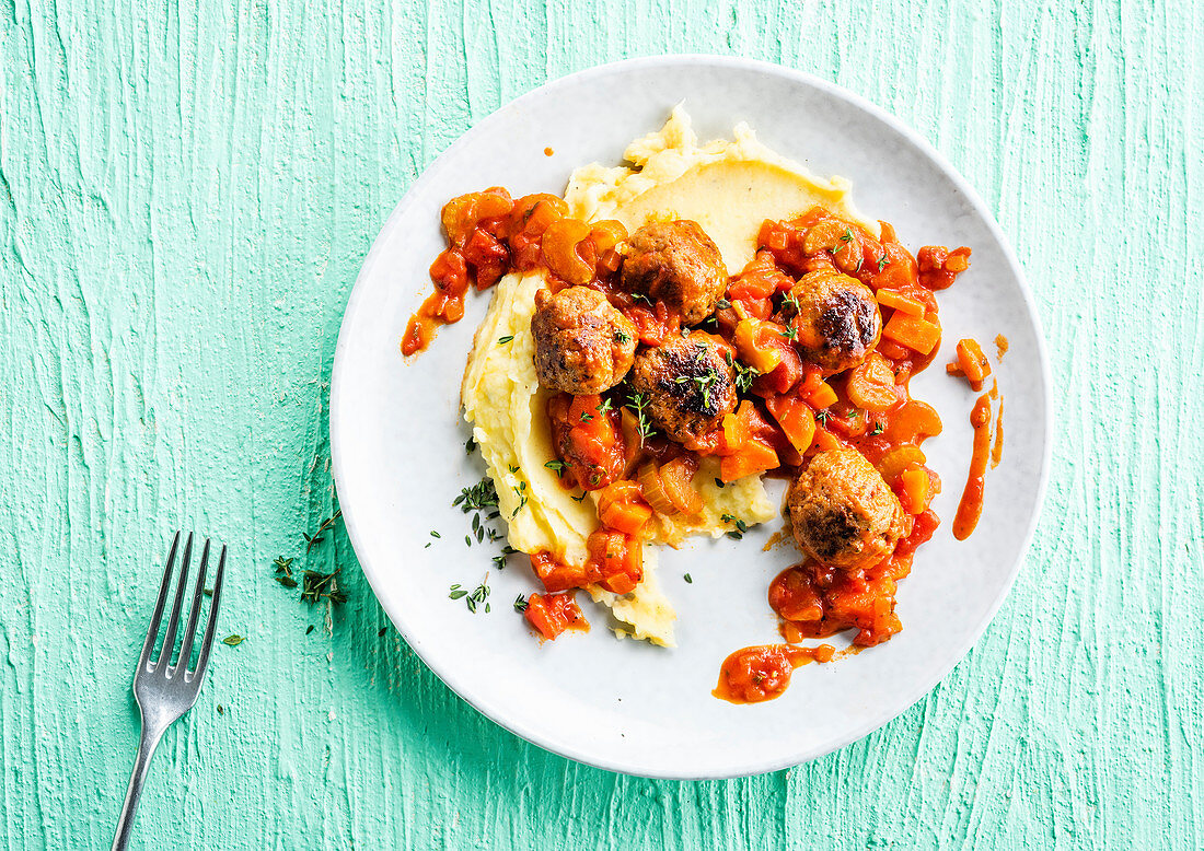 Meatballs in tomato sauce with celery and mashed potatoes
