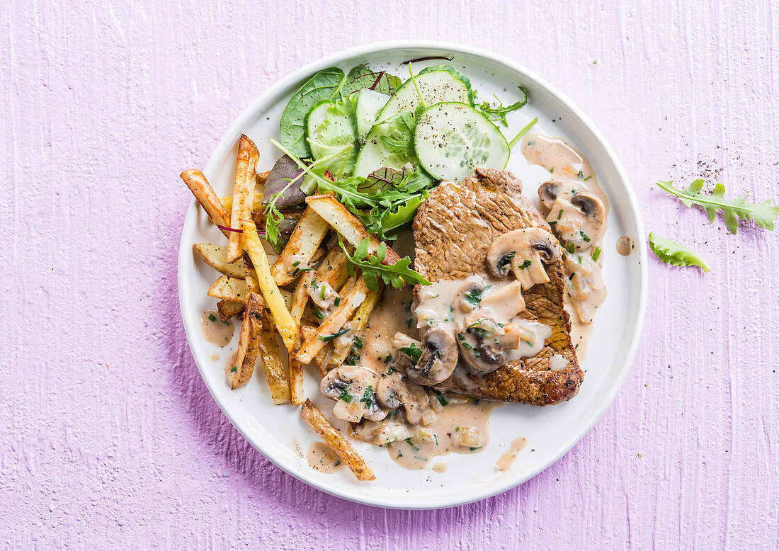 Steak with mushroom sauce and french fries