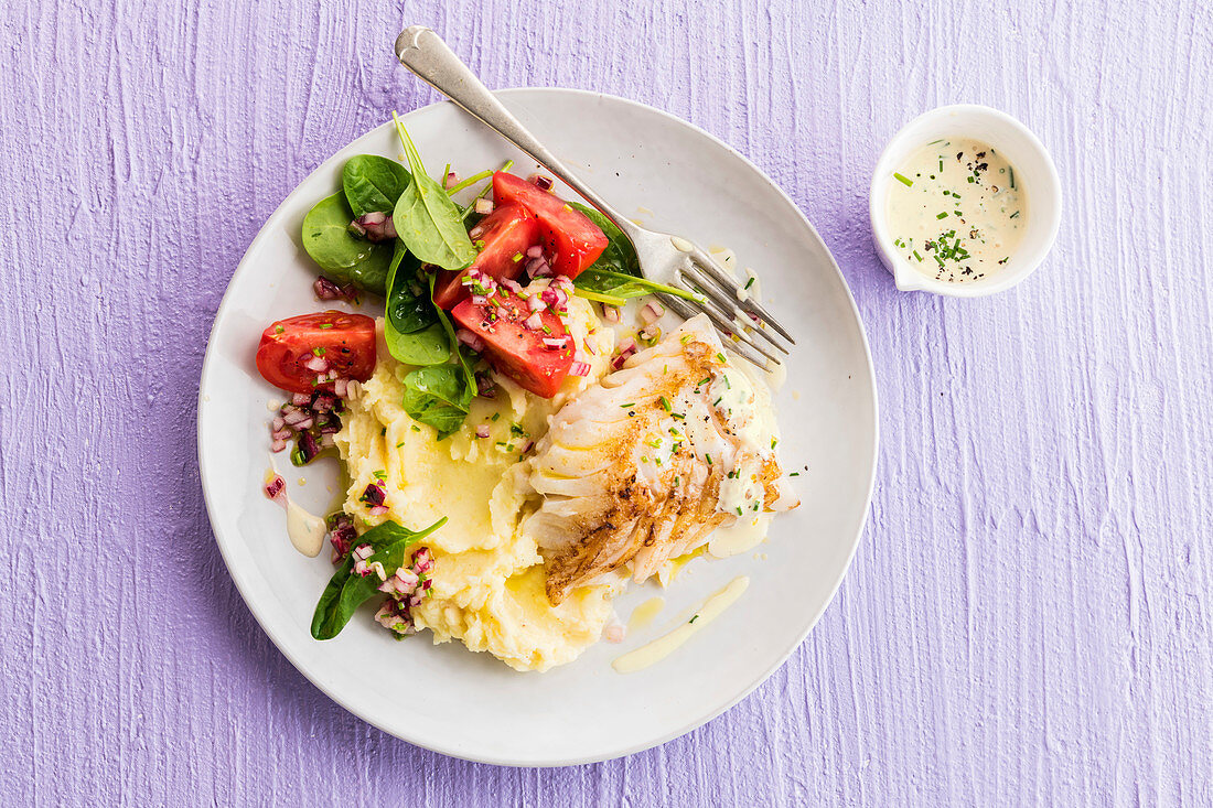 White fish with mustard sauce, mashed potatoes and spinach salad