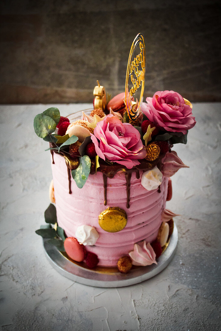 Pink birthday cake decorated with flowers
