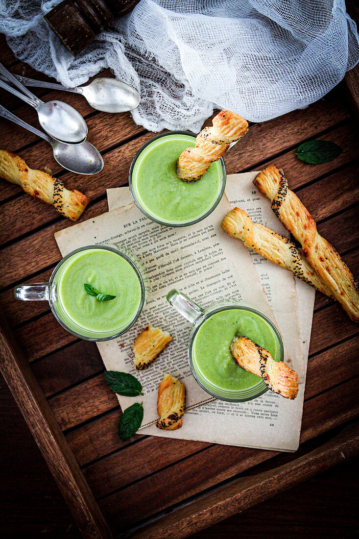 Cold courgette and pea soup with breadsticks