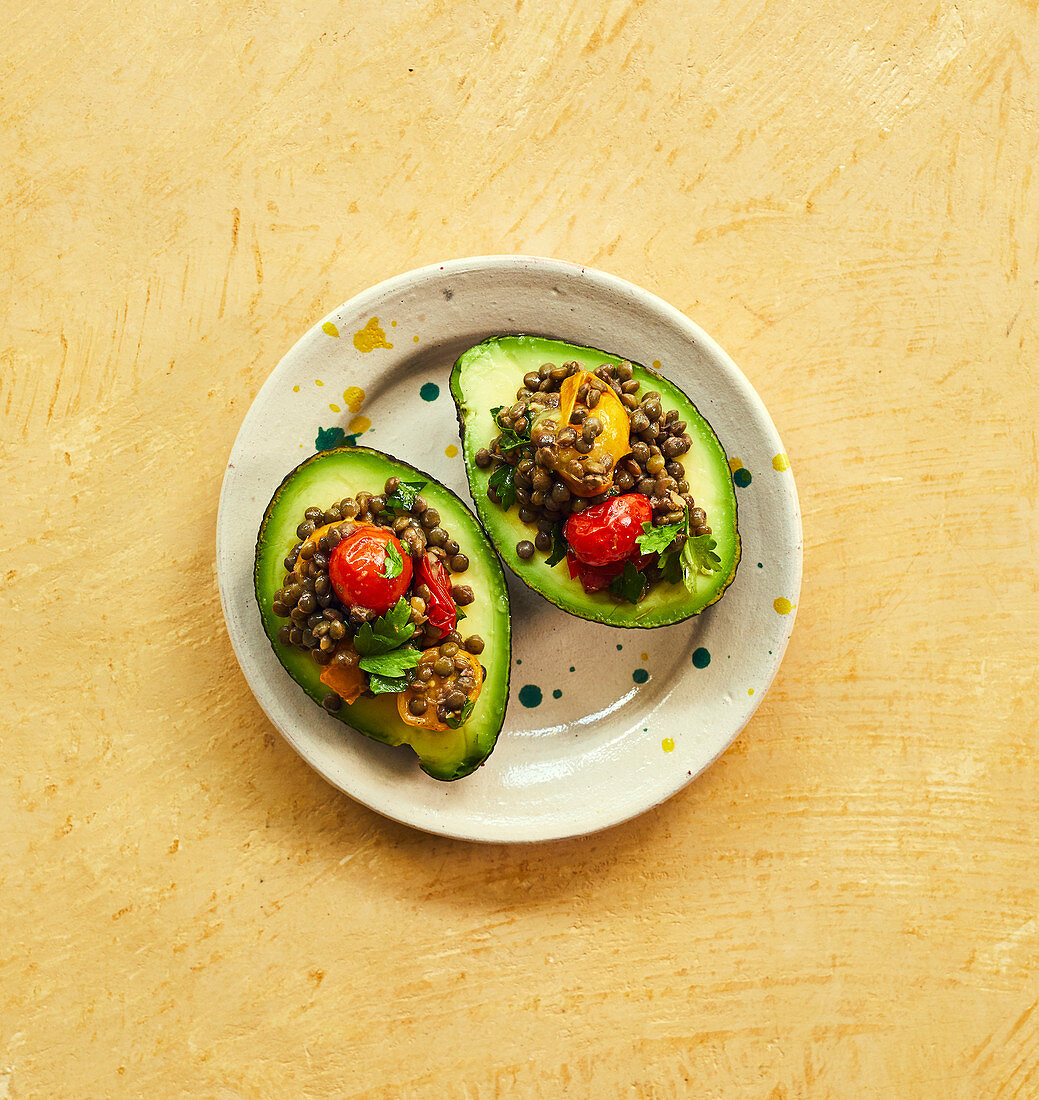 Avocado stuffed with lentils and cherry tomatoes