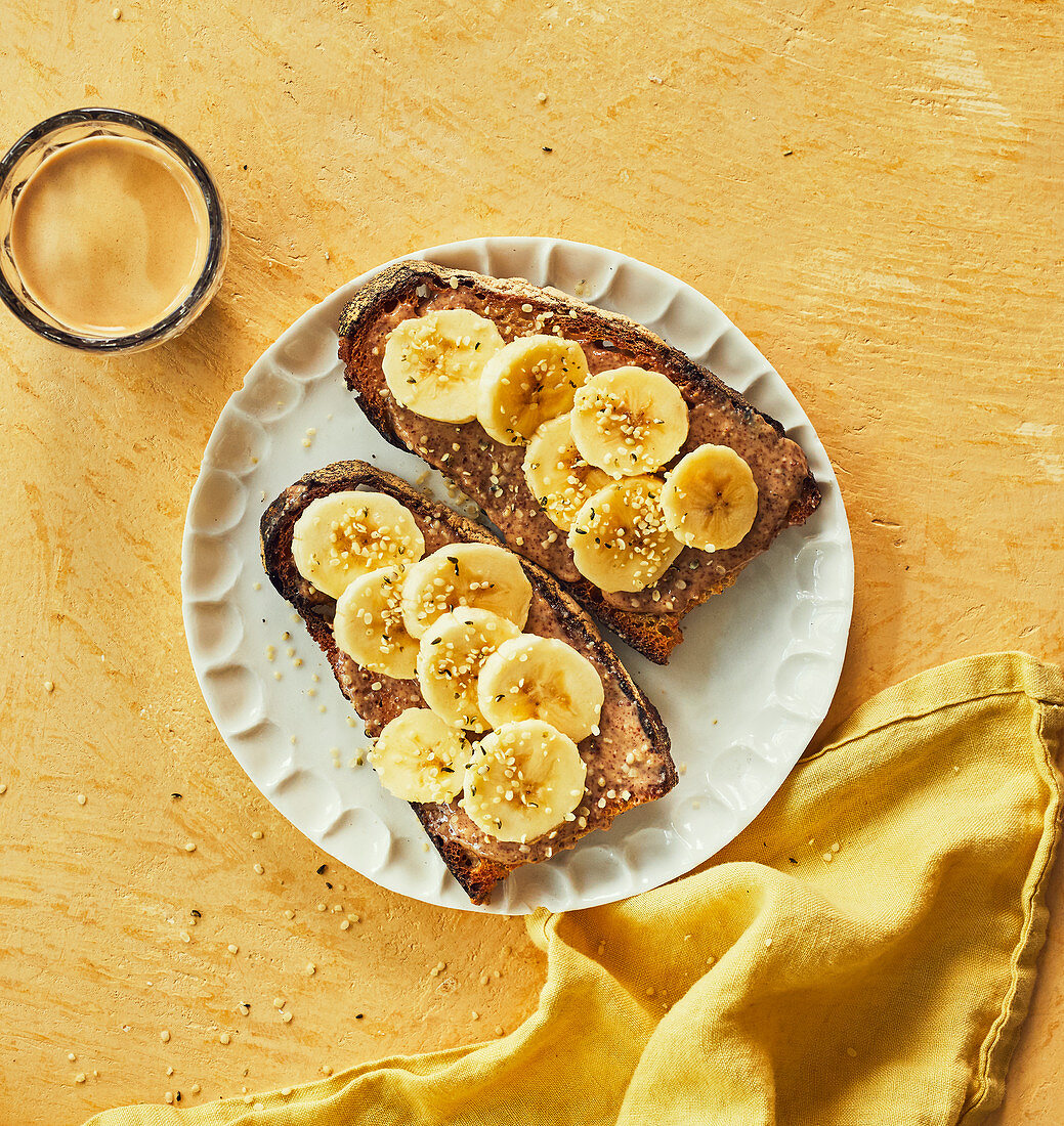 Toasted bread slices with almond butter and banana slices