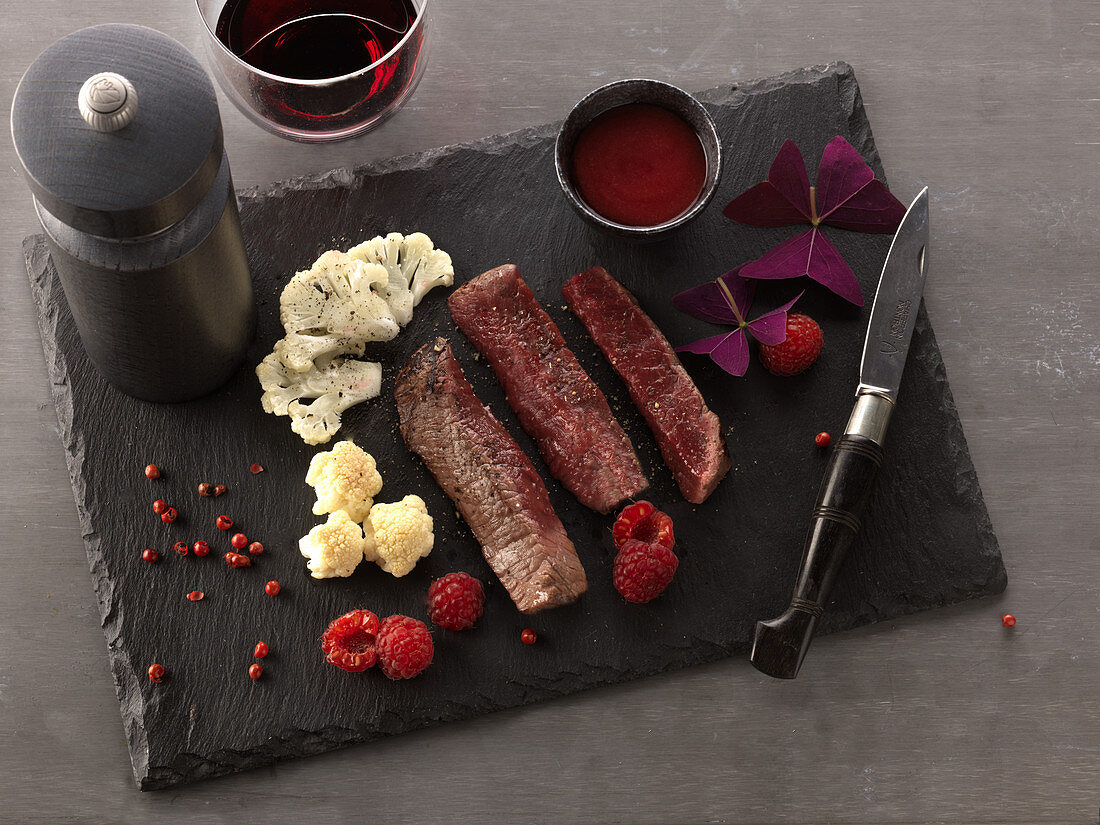 Fillet of beef with side dishes on a slate plate