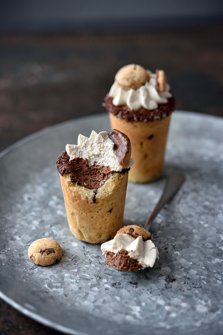 Cup-shaped pastries with chocolate cream filling and whipped cream