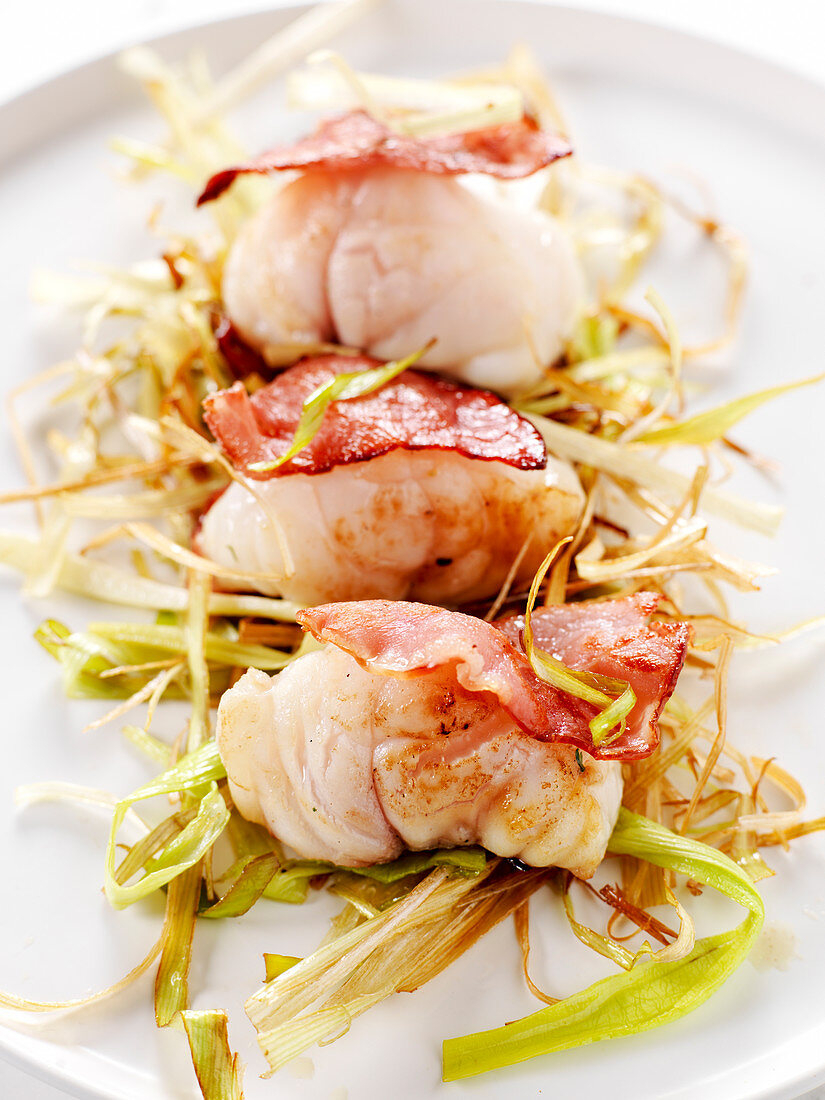 Monkfish medallions with bacon on leek strips