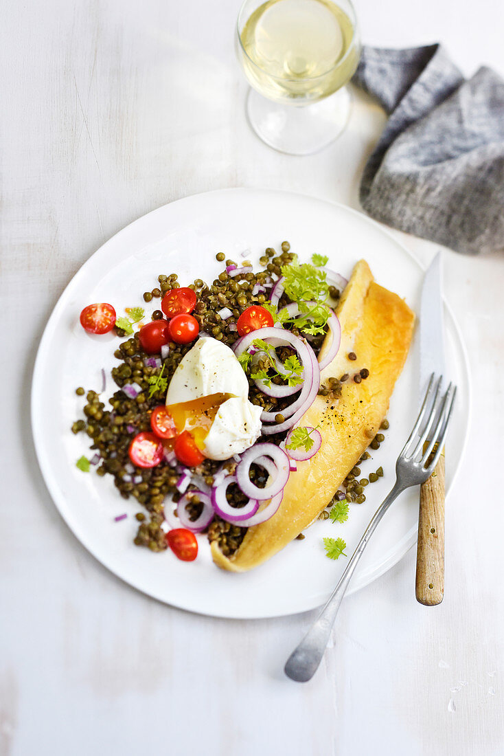 Haddock on lentil salad with cherry tomatoes and a poached egg