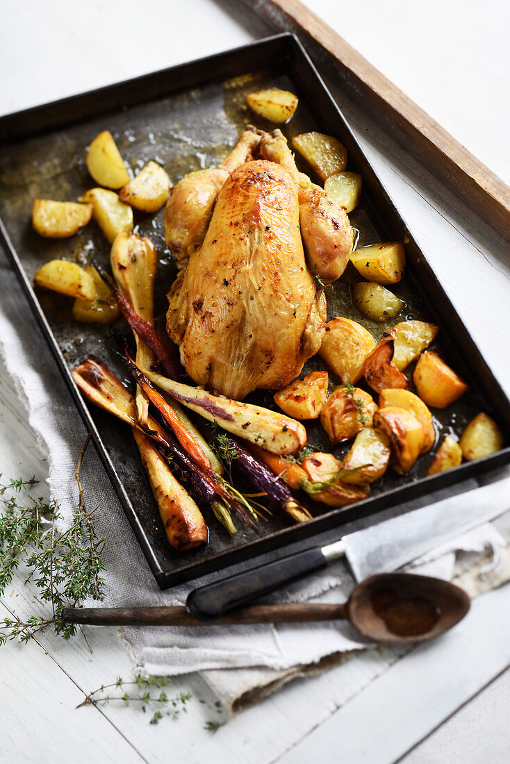 Roast chicken with parsnips, carrots and potatoes