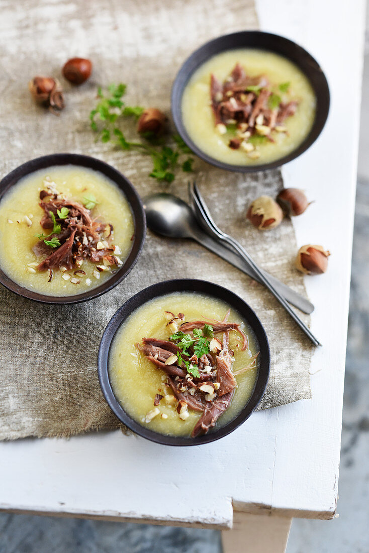 Parsnip soup with duck and hazelnuts