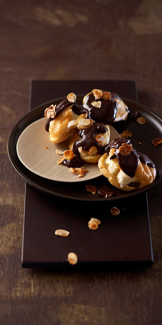 Profiteroles with chocolate icing and almonds