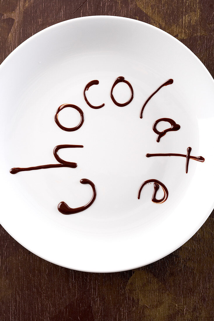 The word 'chocolate' written in melted chocolate