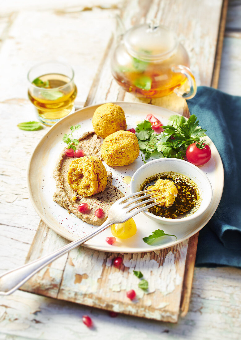 Lentil balls made from coral lentils with hummus and zatar sauce