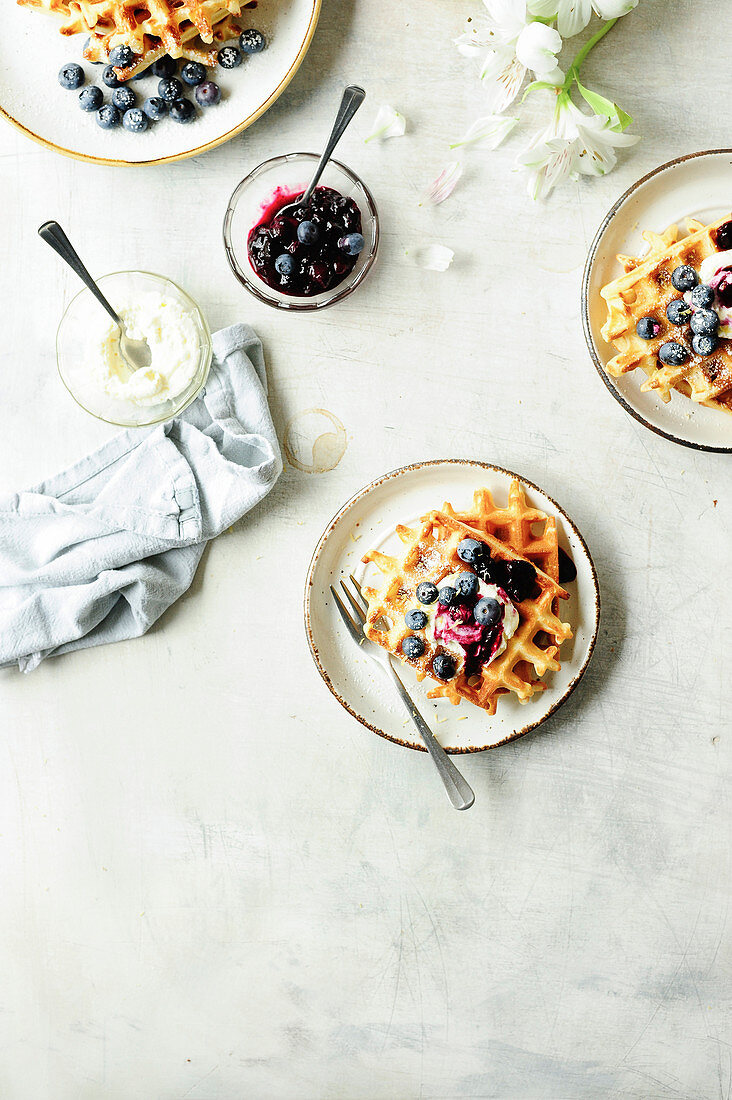 Waffles with cream and blueberry compote