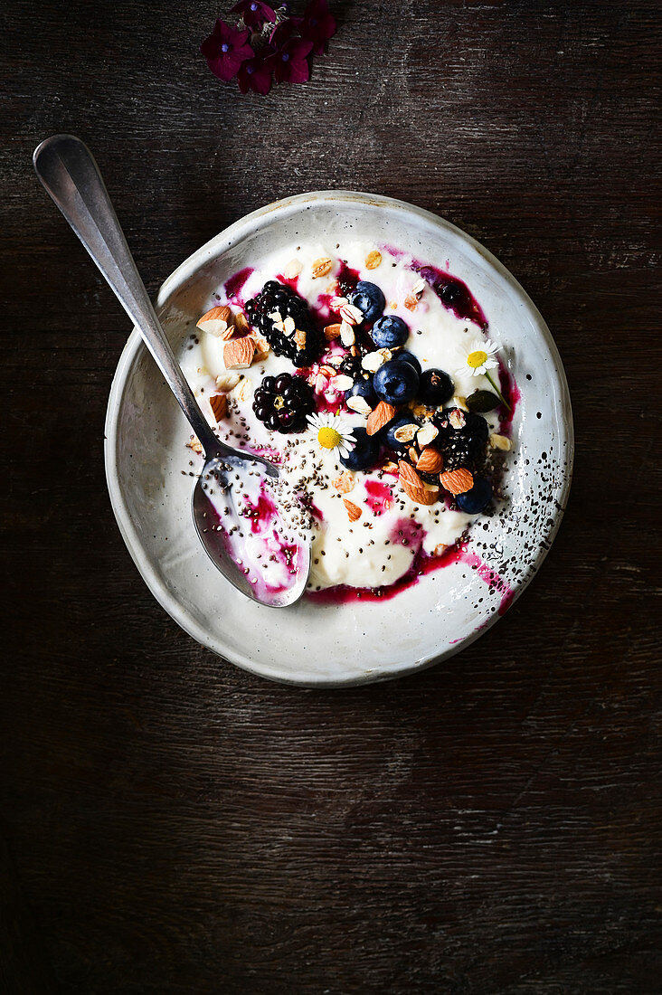 Muesli with yoghurt, almonds, blackberries and blueberries